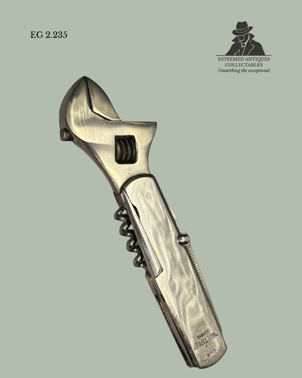 Vintage adjustable wrench with corkscrew on a light green background, featuring the Eterned Antiques Collectables logo.