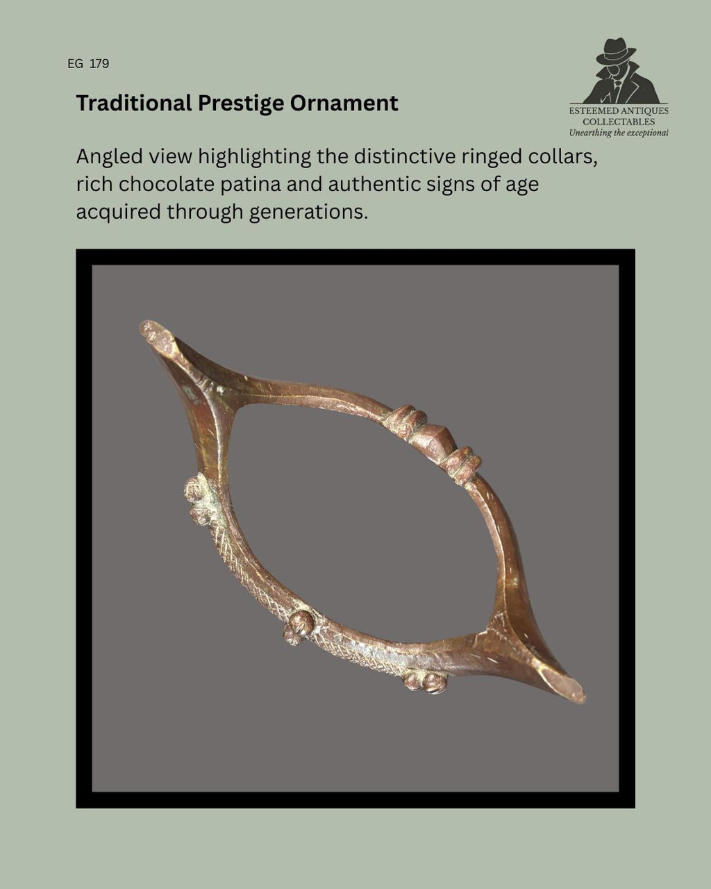 Angled view of a Senufo prestige bronze anklet from Côte d'Ivoire, showing the distinctive ringed collar decoration, projecting terminals, rich chocolate-brown patina, and surface wear consistent with traditional use and age, from the Egon Guenther Collection.