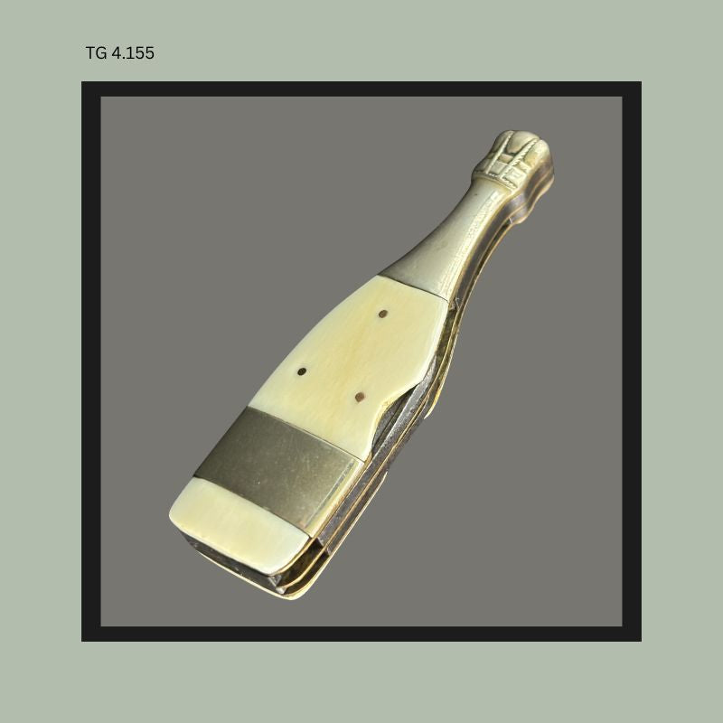 The champagne bottle knife with celluloid handle and  unmarked advertising plate.