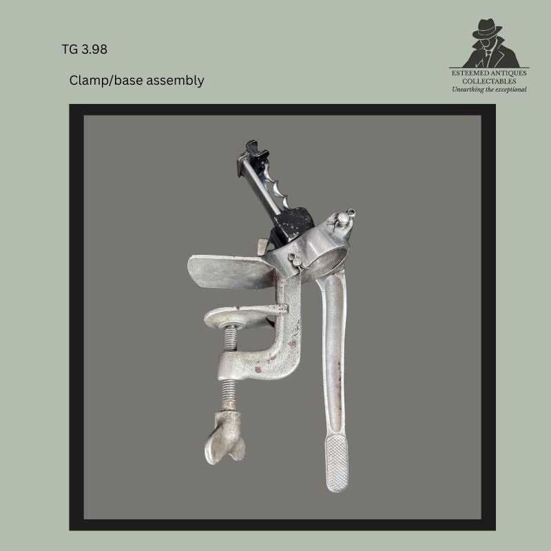 Clamp and base assembly from a Raymond Gilchrist Yankee No. 2 bar-mounted corkscrew, showing the cast metal bench clamp, threaded securing screw, pivoting mounting collar, and operating lever from the Thomas Guenther Collection.