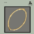 Cast brass-bronze anklet currency from the Frafra or Lobi cultural regions of West Africa, featuring a circular open-form construction with raised segmented decorative bands and worn surface patina, photographed from the Egon Guenther Collection.