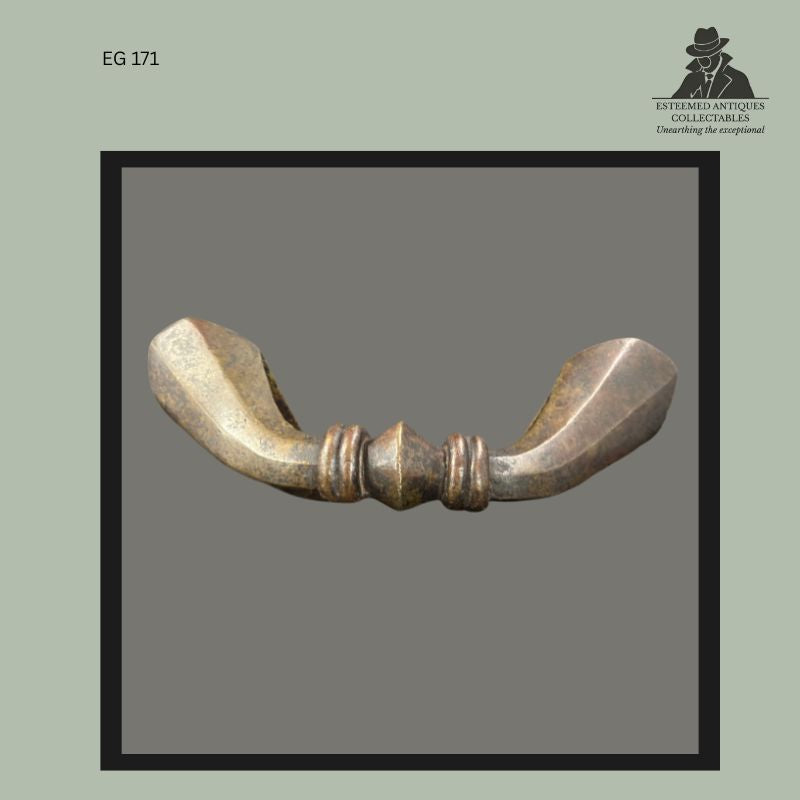 Cast bronze Senufo anklet currency and ceremonial adornment from Côte d’Ivoire, West Africa, featuring a crescent-form body with faceted terminals and central moulded collar decoration, collected by Egon Guenther and preserved in the Guenther family collection.