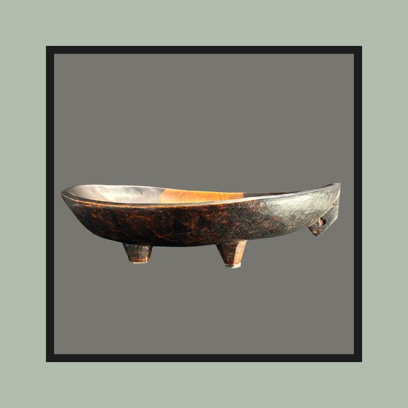 Four-legged hardwood bowl with opposing lug handles, carved from a single block, South Africa, 20th century.