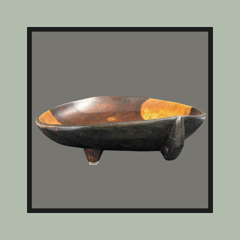 Four-legged hardwood bowl with opposing lug handles, carved from a single block, South Africa, 20th century.