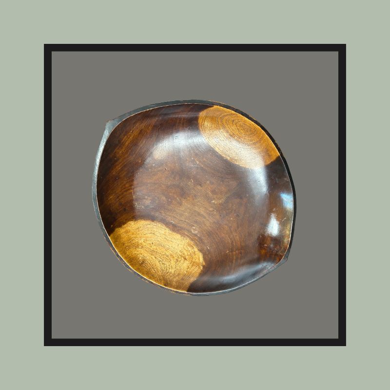 Four-legged hardwood bowl with opposing lug handles, carved from a single block, South Africa, 20th century.