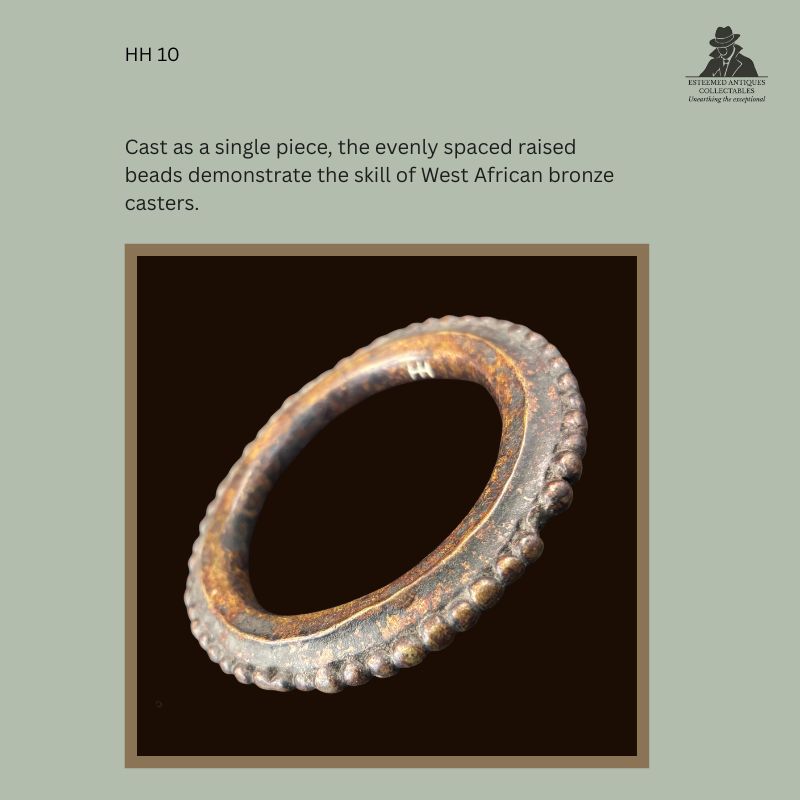 Close-up view of a West African lost-wax cast bronze bracelet showing the evenly spaced raised beaded border cast as a single piece, illustrating traditional metalworking craftsmanship, from the Hans Himmelheber Collection with descent through the Egon Guenther Collection.