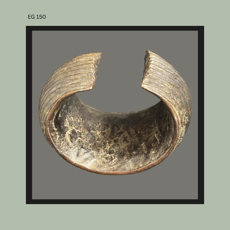 Top view of a hand-built African earthenware vessel showing ribbed exterior decoration and open broken section exposing the thickness, firing texture, and interior surface of the ceramic form.