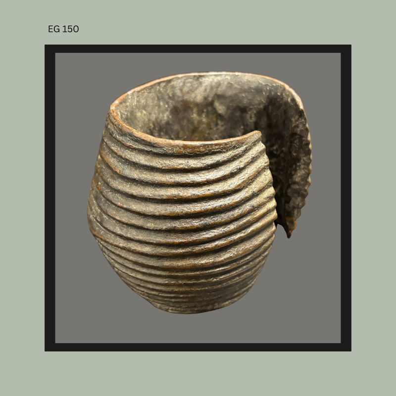 African earthenware vessel with pronounced ribbed coil decoration and partially broken side section revealing the hand-built ceramic structure and interior surface, displaying traditional firing marks and aged patina.
