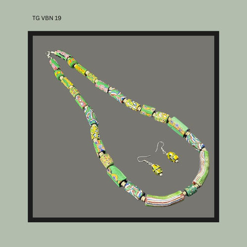 Necklace composed of assorted African trade beads including millefiori and striped wound glass examples in green, yellow, blue, and multicoloured patterns, accompanied by a matching pair of bead earrings in ethnographic jewellery style.