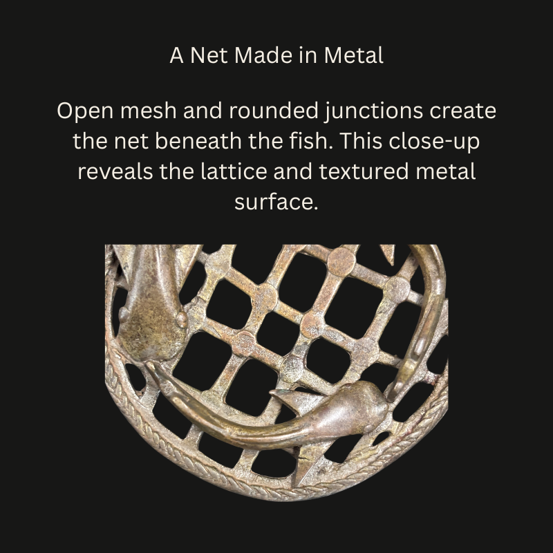 Close-up of an Akan brass openwork object showing a net-like lattice with rounded junctions, raised fish, textured surfaces and a twisted-cord border.