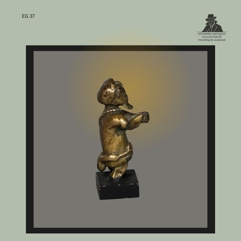 Right side view of an Akan lost-wax cast brass goldweight depicting a male figure with prominent beard and clasped hands in a prayerful pose, Ashanti culture, Ghana, from the Egon Guenther Collection by family descent to the Thomas Guenther Collection.