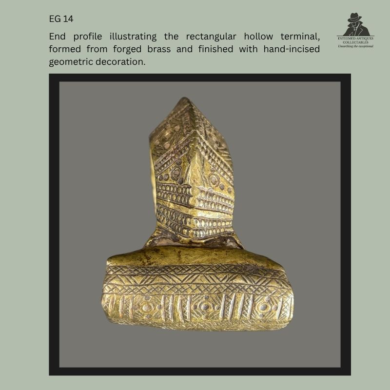 End profile of a traditional Amhara–Tigray brass anklet from Ethiopia, showing the rectangular hollow terminal with hand-incised geometric decoration and forged brass construction, Egon Guenther Collection provenance.