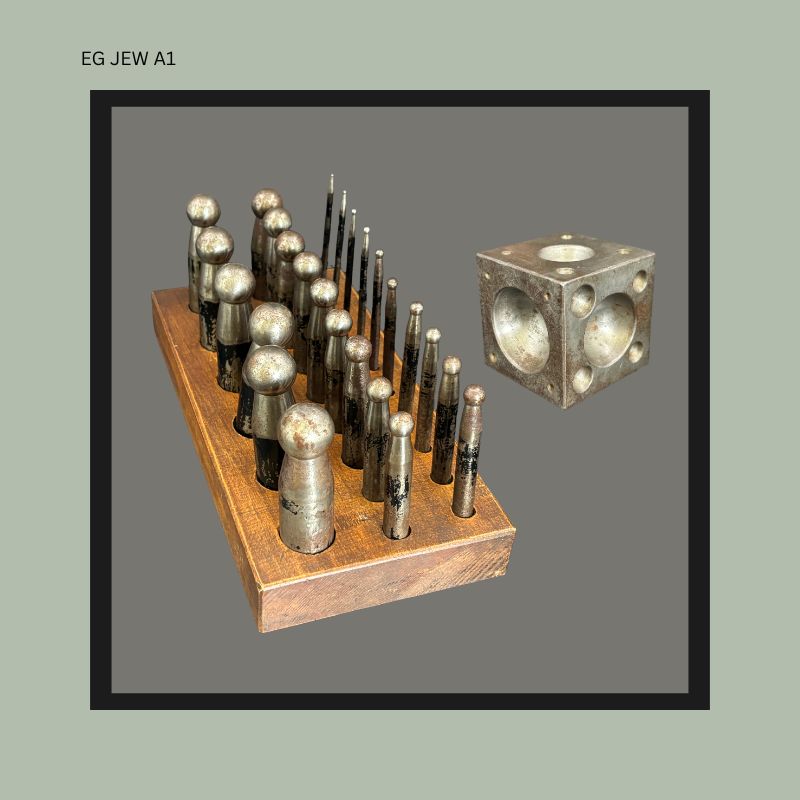 Side view of an antique German jeweller’s doming punch set with graduated steel dapping punches arranged in a fitted wooden stand beside a machined steel doming block used by  Egon Guenther passed on to Thomas Guenther through inheritance.