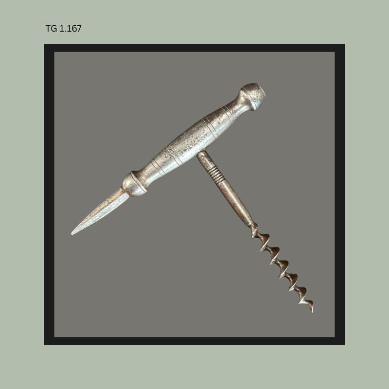 Antique metal T-handle corkscrew with integrated ice pick spike and turned barrel-form handle, featuring a steel worm and tapered piercing tool, from the Thomas Guenther Collection.