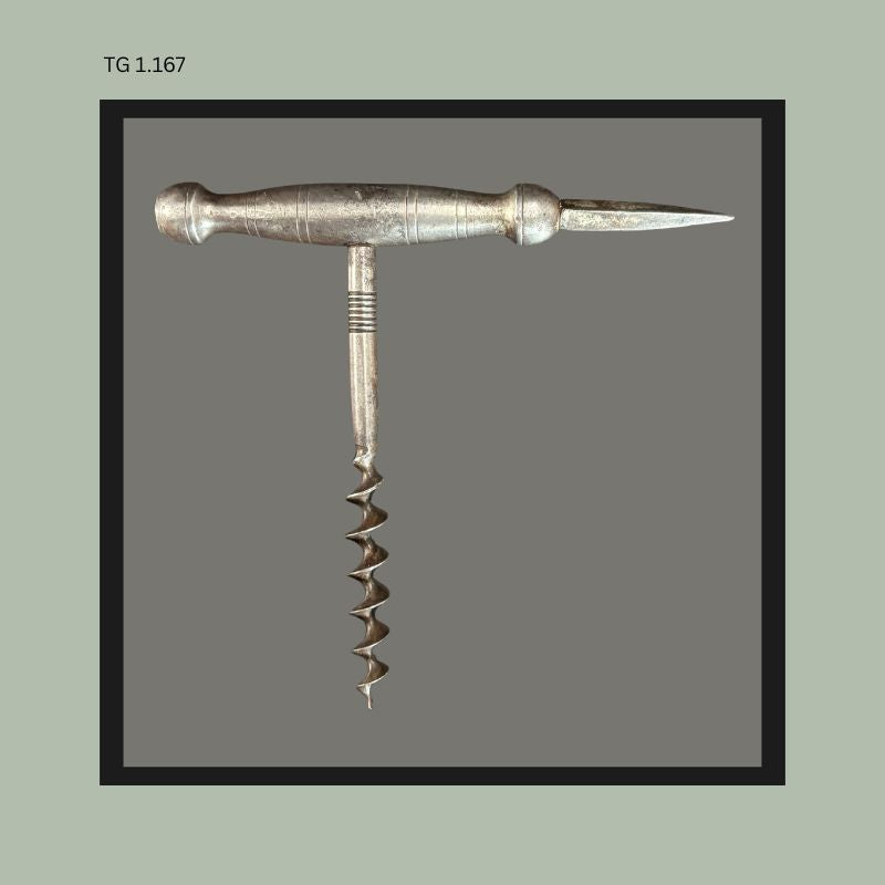 Antique metal T-handle corkscrew with integrated ice pick spike, featuring a turned cylindrical handle and steel worm, likely European, shown in closed configuration from the Thomas Guenther Collection.
