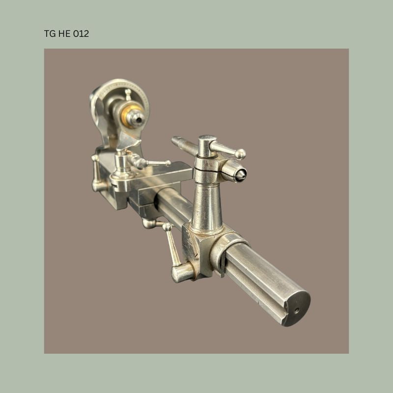 Precision watchmaker’s or jeweller’s metalworking lathe in polished steel with adjustable tool rest and geared headstock, early 20th century workshop instrument used for fine mechanical turning and horological work.