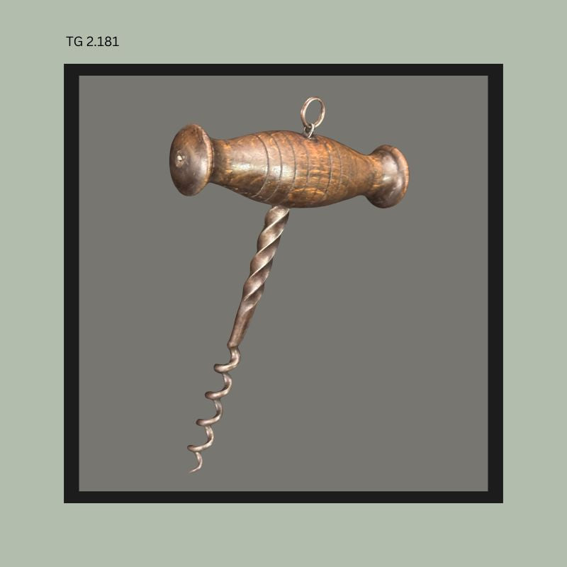 Antique wooden T-handle corkscrew with turned wood grip, twisted spiral shaft, and hand-formed helical worm, shown in rear angled view from the Thomas Guenther Collection.