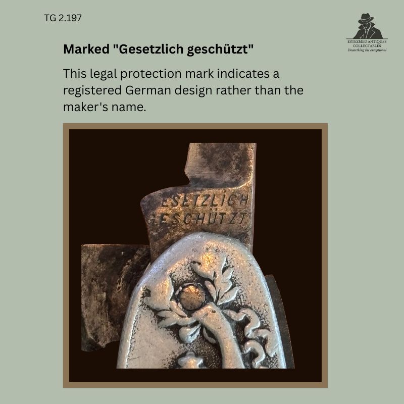 Close-up detail of the blade tang on an Art Nouveau aluminium and steel gentleman's pocket knife showing the German "Gesetzlich geschützt" registered design mark above the embossed floral decoration, Germany, circa 1900–1925, Thomas Guenther Collection.