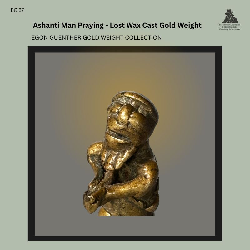 Close-up view of an Akan Ashanti lost-wax cast brass gold weight depicting a male figure with clasped hands, Ghana, showing stylised facial features and worn surface patina from the Egon Guenther Collection.