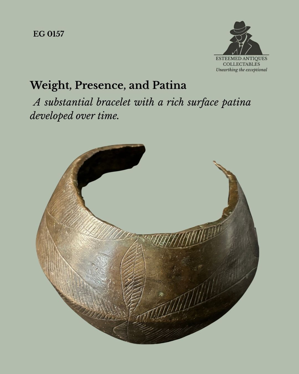 Close view of a Baoulé cast brass open cuff bracelet from Côte d'Ivoire, showing its substantial form, incised geometric decoration, deep brown patina, and provenance from the Egon Guenther Collection.