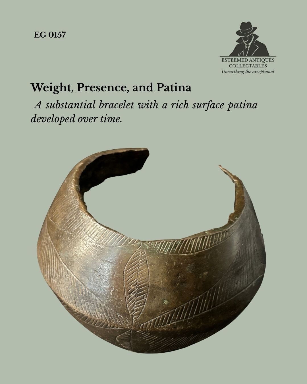 Close view of a Baoulé cast brass open cuff bracelet from Côte d'Ivoire, showing its substantial form, incised geometric decoration, deep brown patina, and provenance from the Egon Guenther Collection.