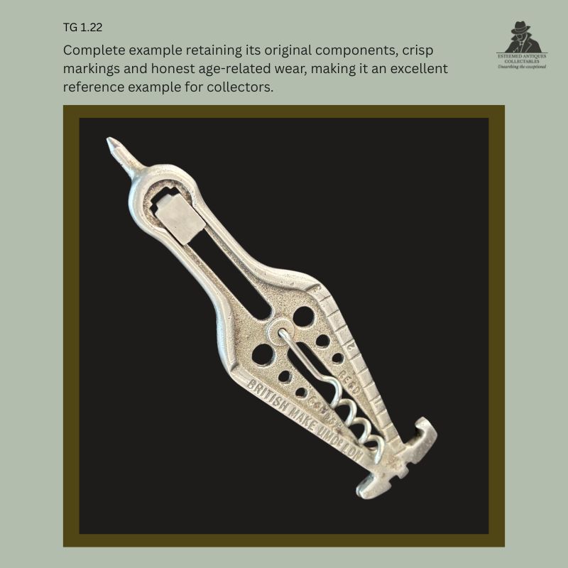 British UMC cast alloy combination corkscrew shown in original collector's condition, retaining its folding worm, capsule cutter, cap lifter, crisp maker's markings and honest age-related wear, photographed against a black background.