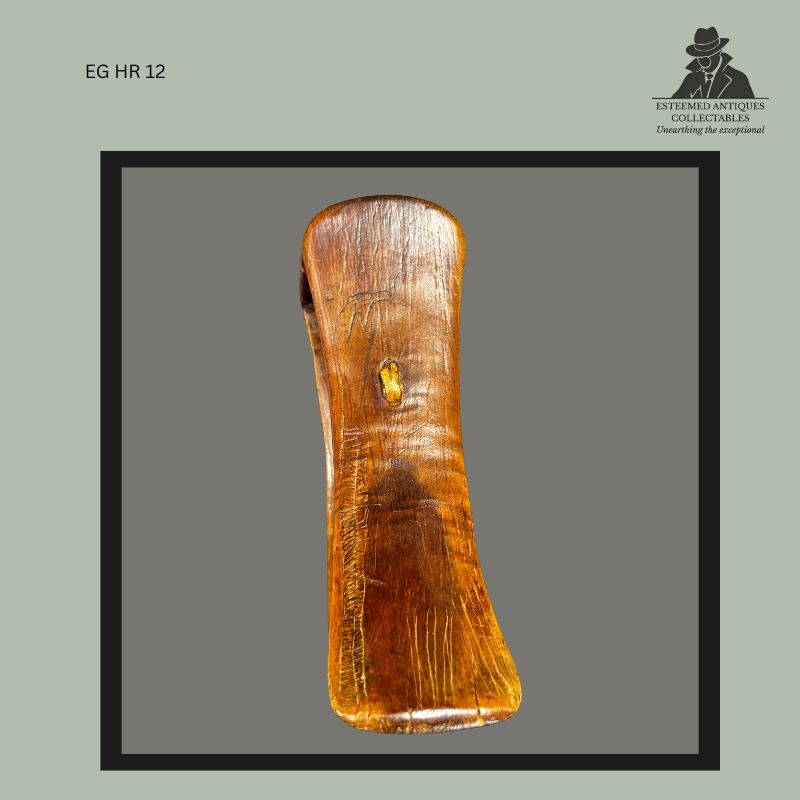 Side profile view of an East African carved wooden headrest attributed to the Turkana or Karamojong cultural region, showing the elongated support column, smooth polished patina, age-related wear, and hand-carved construction characteristic of pastoralist headrests collected in East Africa.