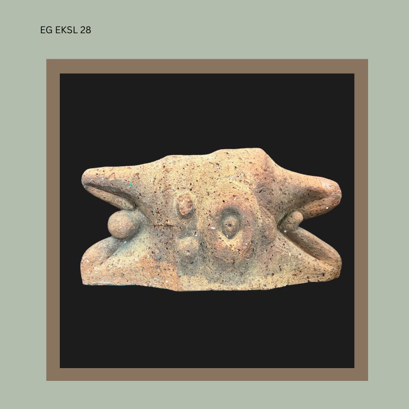 Terracotta sculptural head by South African artist Ezrom Legae, showing an abstracted zoomorphic form with pierced nostrils, rounded protruding eyes, and hand-modelled surface texture, from the Egon Guenther Collection.