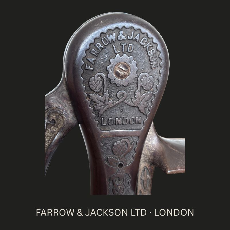 Close-up of the raised FARROW & JACKSON LTD LONDON maker’s mark with hop-and-leaf ornament on an English cast-iron counter-mounted bar corkscrew, c.1900–1915.
