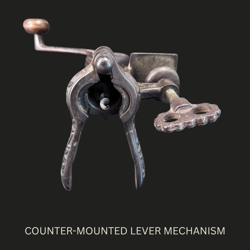 Front view of the Farrow & Jackson Safety counter-mounted cast-iron bar corkscrew, showing the hinged bottle-gripping levers, central worm, side clamp and hand-crank mechanism.