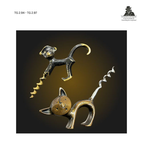 Pair of figural corkscrews modelled as a cat and a monkey, cast in brass-toned metal with integrated spiral worms, whimsical animal-form barware and collector corkscrews from the Thomas Guenther Collection.