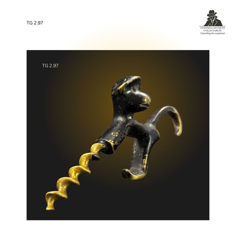 Figural monkey corkscrew with stylised primate form, dark patinated cast metal body and cast brass worm, shown in side profile with curved tail handle and integral boot pull form, collectible figural barware from the Thomas Guenther Collection.