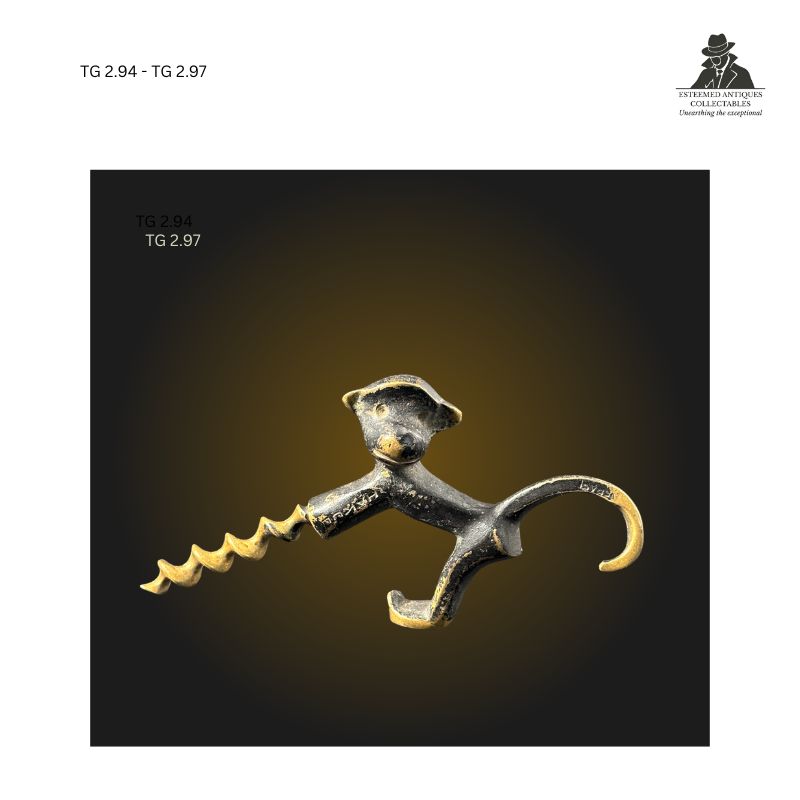 Cast metal monkey-form corkscrew shown from the front, featuring a stylised primate head, outstretched limbs creating an ergonomic handle, and an integrated corkscrew worm, displaying wear and patina consistent with use as a novelty wine accessory and collector's corkscrew.