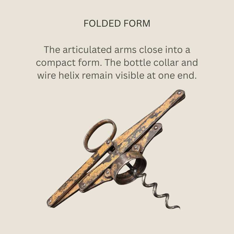 Heeley’s Pullezi steel concertina corkscrew in folded form, showing overlapping riveted arms, an oval finger ring, bottle collar and exposed wire helix, with worn surface finish.