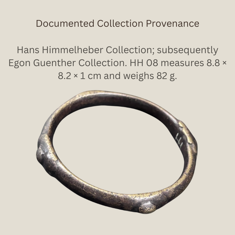West African copper-alloy bangle HH 08 with a rounded hand-finished form, dark patina and restrained raised projections, formerly in the Hans Himmelheber and Egon Guenther collections.
