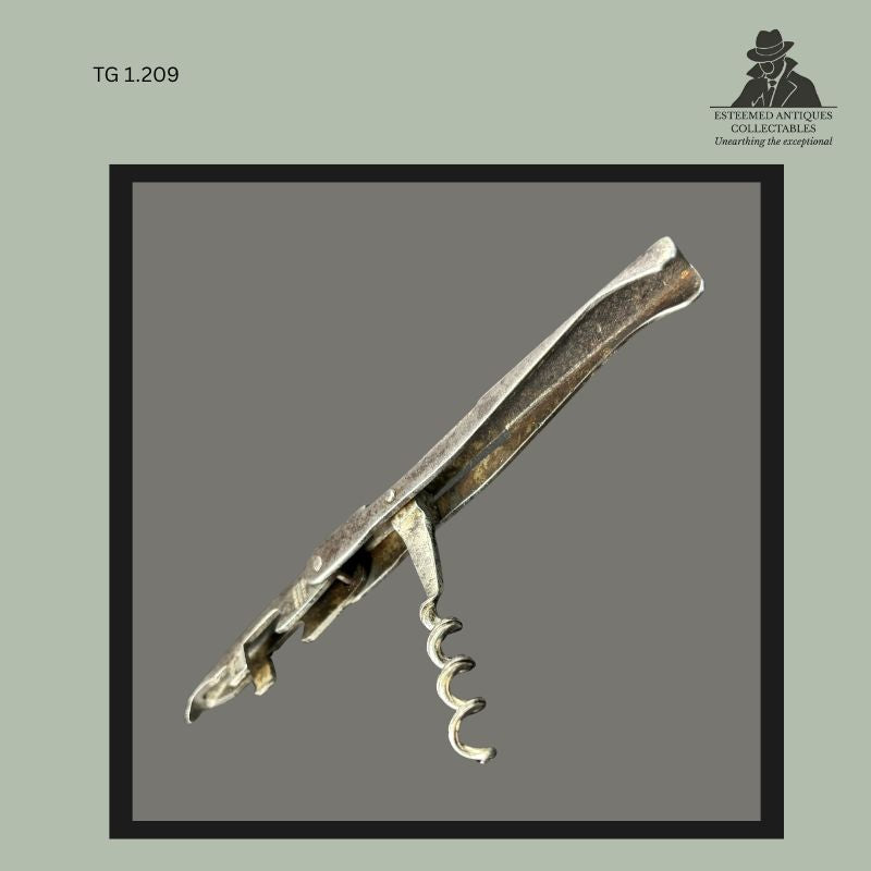 Folding pocket corkscrew attributed to John Watts, England, incorporating a wire helix worm, crown-cap bottle opener and pointed can opener within a pressed steel frame, shown partially opened with the worm extended.