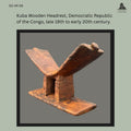 Kuba carved hardwood headrest from the Democratic Republic of the Congo, featuring a V-shaped neck support raised on two rectangular uprights above a flat rectangular base, with a rich worn patina and visible hand-carved construction, from the Egon Guenther Collection.
