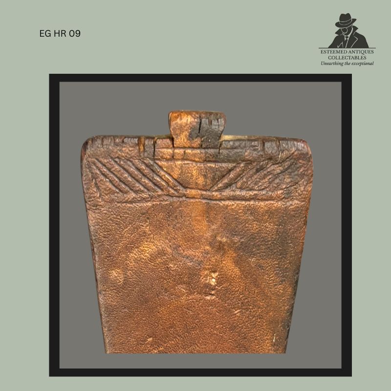Detail view of a Kuba carved wooden headrest from the Democratic Republic of the Congo, showing the upper section with projecting terminal finial and geometric relief carving along the rim, displaying worn surface patina and hand-carved construction characteristic of Central African prestige headrests.