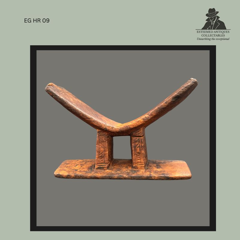 Kuba carved wooden headrest from the Democratic Republic of the Congo, featuring a crescent-shaped support on two vertical pillars above a rectangular base, with rich surface patina and evidence of prolonged use, from the Egon Guenther Collection.