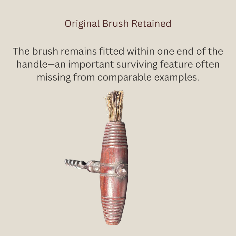 Detail of a late Victorian English straight-pull corkscrew showing the original bristle brush retained within one end of the finely turned wooden T-handle.