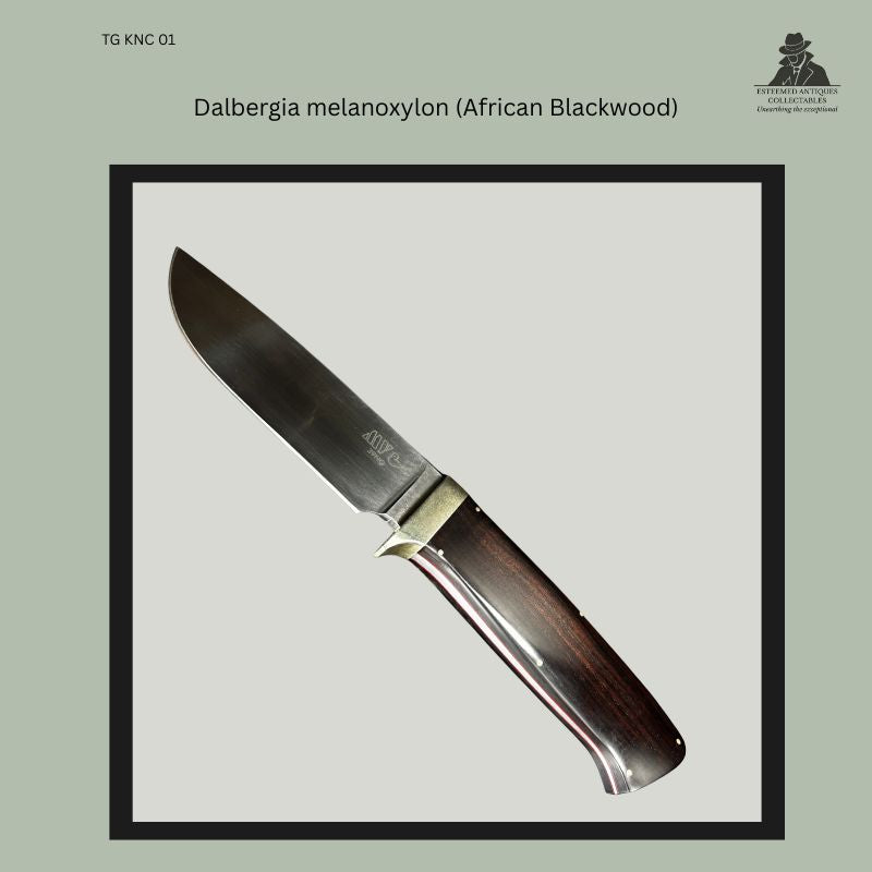 Detail view of a handmade hunting knife by Marius van der Vyver, South Africa, 1989, showing polished Dalbergia melanoxylon (African Blackwood) handle scales with German silver fittings and a K110 steel blade bearing the maker’s mark.