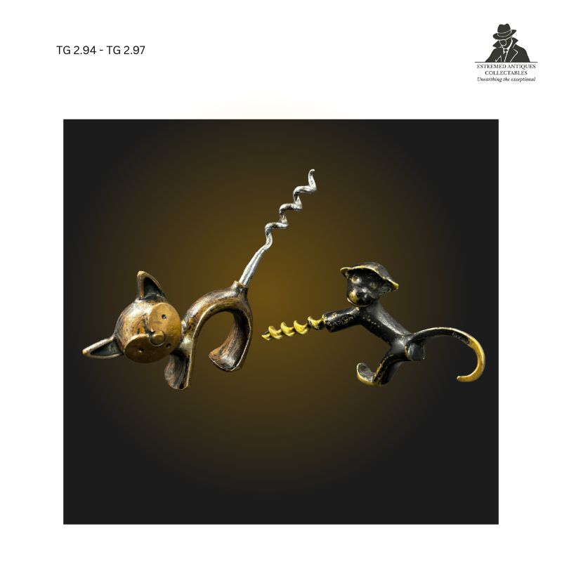 Pair of figural cast metal corkscrews comprising a smiling cat-form corkscrew attributed to England and a monkey-form corkscrew attributed to Israel, shown side by side with integrated helix worms and stylised animal bodies, collector-grade novelty wine accessories from the twentieth century.