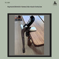 Side view of Raymond Gilchrist's Yankee No. 2 bar-mounted mechanical corkscrew clamped to a tabletop, showing the cast metal frame, black operating handle, rack-and-pinion mechanism, and bench-mounting clamp, from the Thomas Guenther Collection.