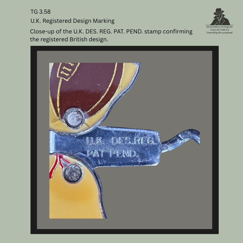 Close-up detail of the shank on a British figural rugby player corkscrew showing the stamped registration marking "U.K. DES. REG. PAT. PEND.", documenting the registered design on the nickel-plated steel mechanism.