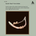 Senufo-attributed boat-form copper-alloy anklet from Côte d’Ivoire, with strongly upturned terminals, raised central bands and aged patinated surface, Egon Guenther Collection, reference EG 184.