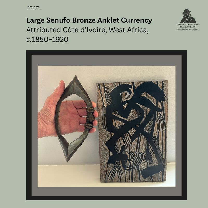 Large Senufo bronze anklet currency attributed to Côte d’Ivoire, West Africa, cast by the lost-wax process with pointed terminals and central ribbed expansion, shown in hand for scale, from the Egon Guenther Collection.