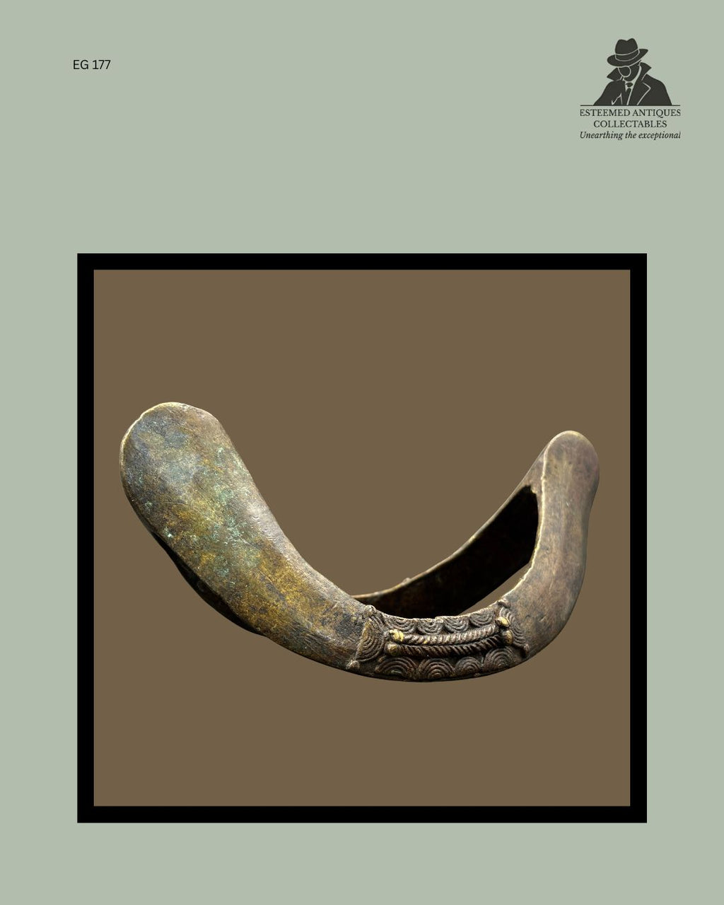 Side profile of a Senufo bronze prestige anklet from Côte d’Ivoire, showing the substantial cast construction, rounded terminals, decorative relief banding, surface patina, and wear consistent with long-term use, from the Egon Guenther Collection.