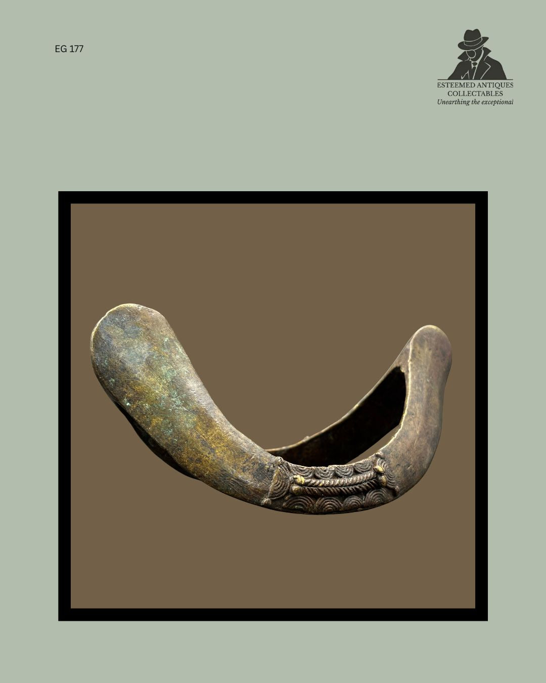Side profile of a Senufo bronze prestige anklet from Côte d’Ivoire, showing the substantial cast construction, rounded terminals, decorative relief banding, surface patina, and wear consistent with long-term use, from the Egon Guenther Collection.