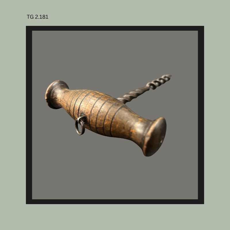 Antique direct-pull corkscrew with turned wooden handle, iron spiral shaft and helical worm, showing ring attachment beneath the handle, from the Thomas Guenther Collection.