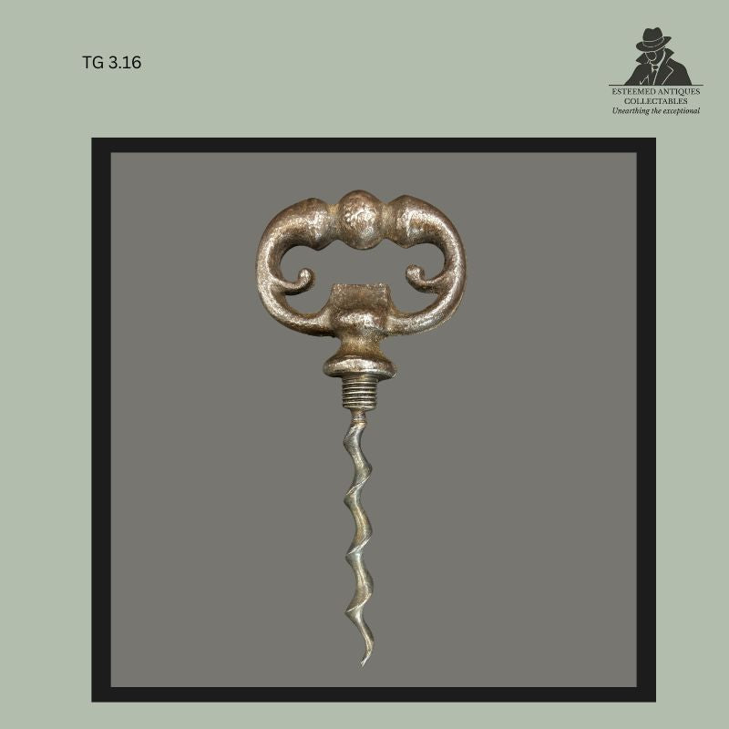 Victorian cast metal cellar-key corkscrew with ornate symmetrical scroll handle, fitted with a tapered speed worm and decorative collar, a traditional wine-opening implement from the late 19th century, Thomas Guenther Collection.